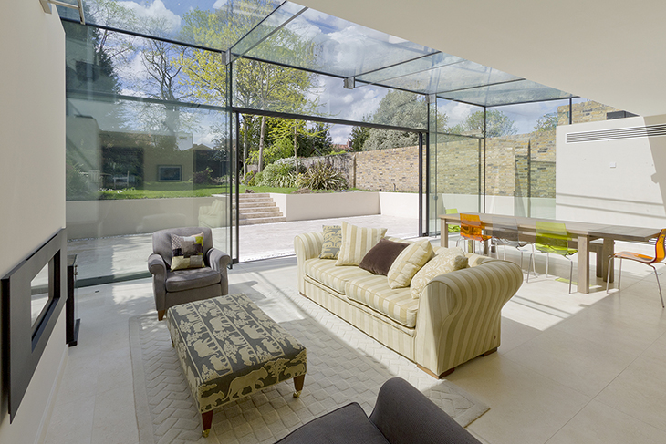 The expansive glazing opens to connect the interior and exterior spaces seamlessly.