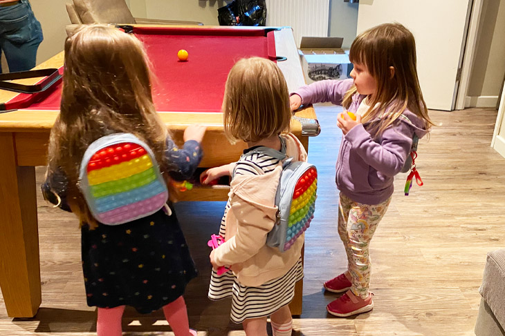 Three of the children playing their own special version of pool.